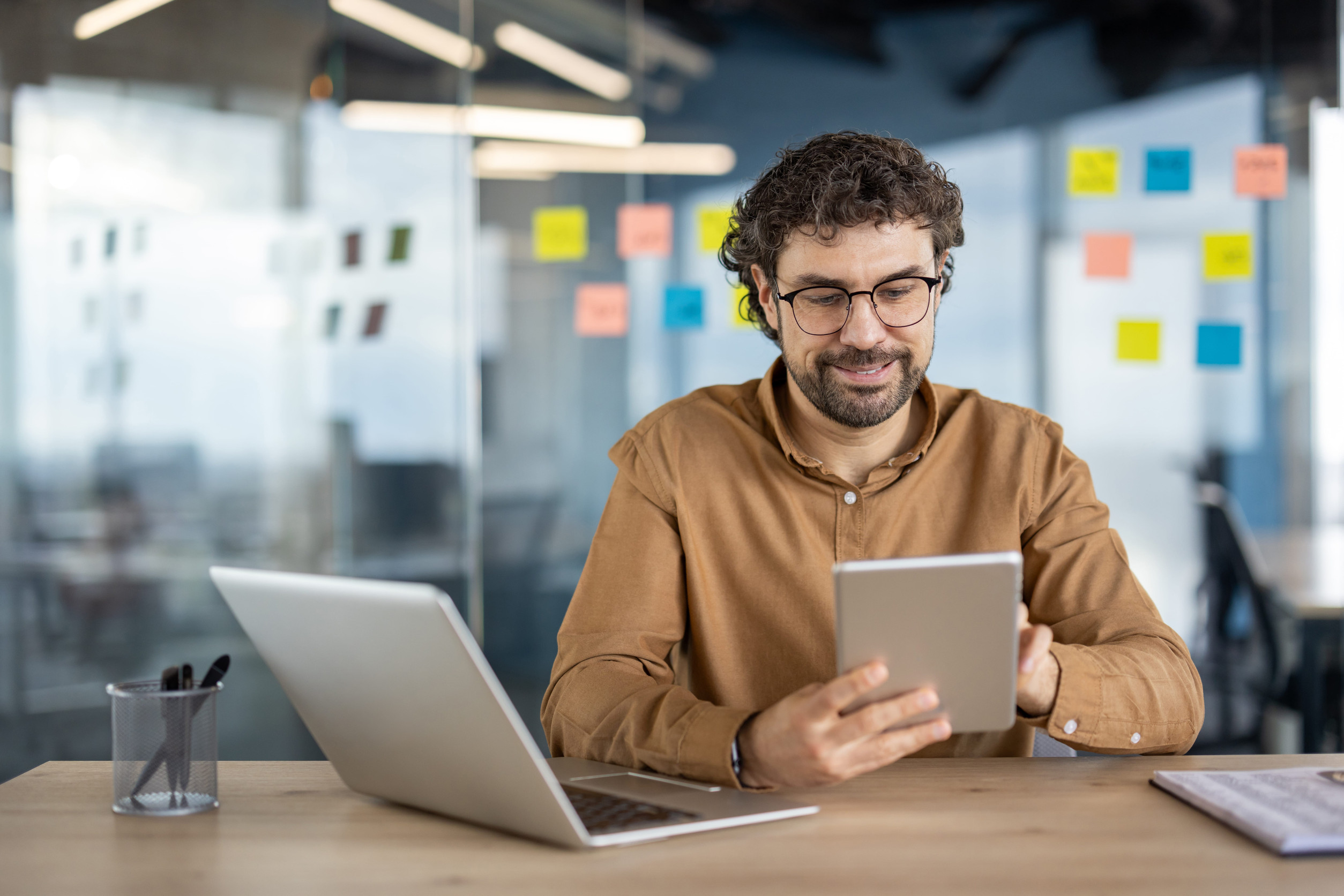 Small business owner using a tablet to manage customer inquiries and automate daily business tasks with AI tools.